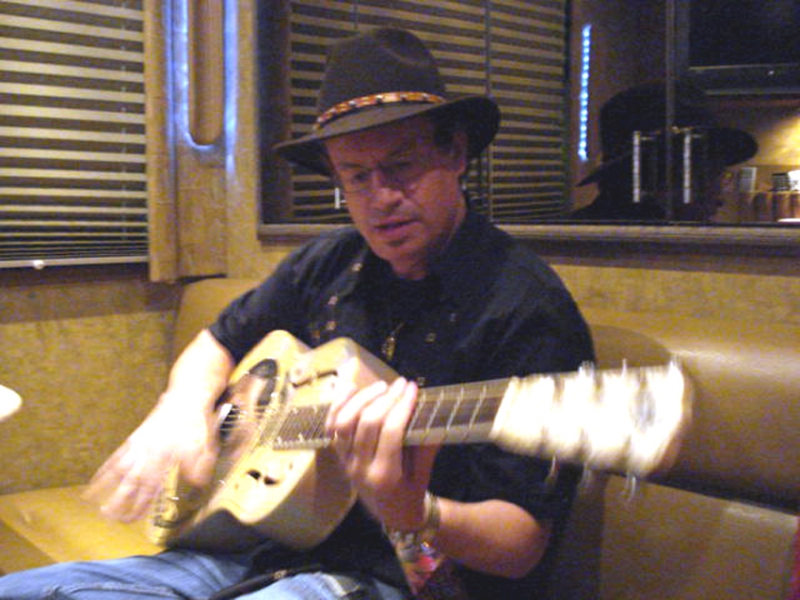 Albany, NY, June 7, 2007: Jimmy finding a vintage acoustic steel guitar in the lounge area of the tour bus.