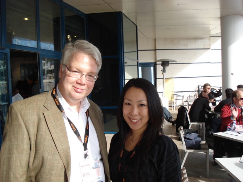 MIDEM 2010 ñ Jochen B meeting with Tomoko Kawabe, Purchasing Manager at Disk Union, ZOHOís distributor in Japan. Also enjoying a few moments of sun on the outside terrace of the A2IM stand.