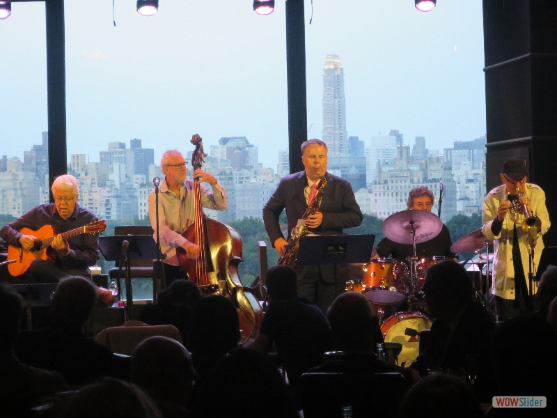 August 15, 2018: another of the great music traditions in New York are the two weeks of Brazilian jazz performances of ZOHO artists Trio da Paz, with assorted guests, here including saxophonist Harry Allen, and trumpeter Claudio Roditi. Look at the magnificent Manhattan East Side skyline, east of Central Park, in the background, a truly magical place.